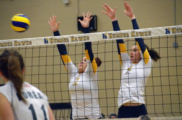 PHOTO BY GEORGE HALIM Carley Uden (left) and Ally Newman go up for a block first as Humber routed Boreal 25-3 in the first set at home, on Dec. 1.