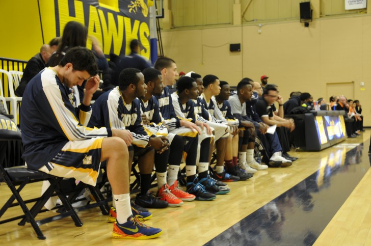 The Humber Hawks men's basketball team looks on as they take on the rival Mohawk Mountaineers.