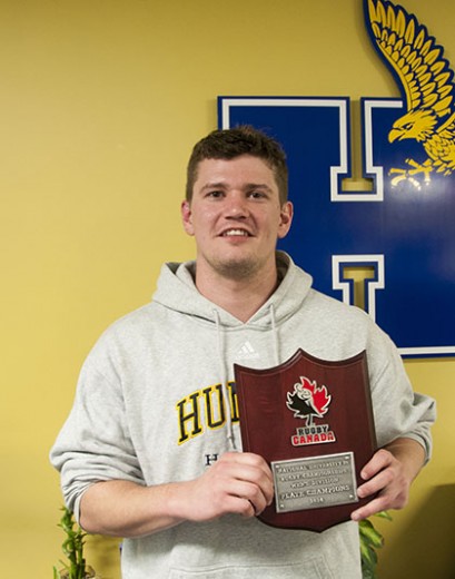 Graham Dewar stands with the plaque awarded to the Humber Hawks for their Plate Division title. (PJ VALOIS)