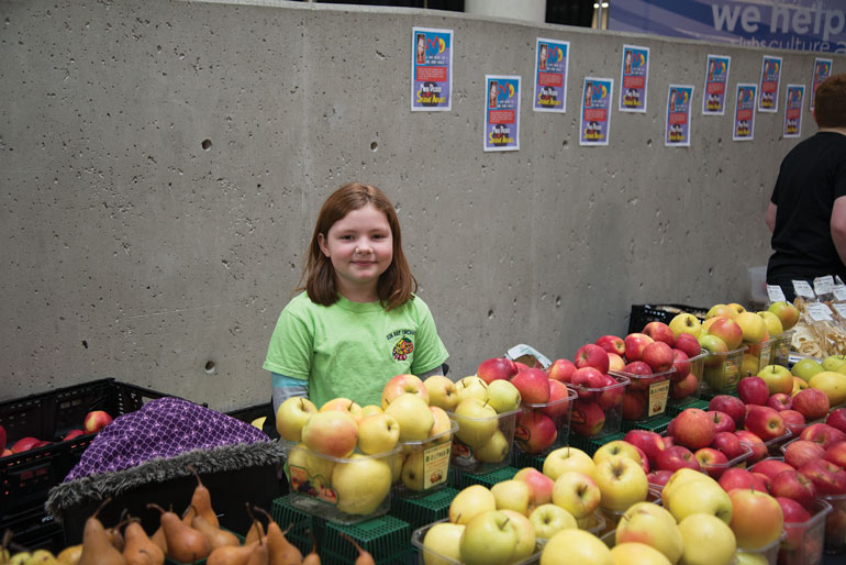 Shannen, daughter of Sun-Ray Orchards owner, Larry Short, sells apples and pears at the Humber College marketplace.