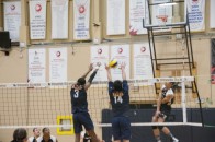 (Elliott Willams) Hawks Kobe John (3) and Adam Kinoshita (14) block a spike from Conestoga.